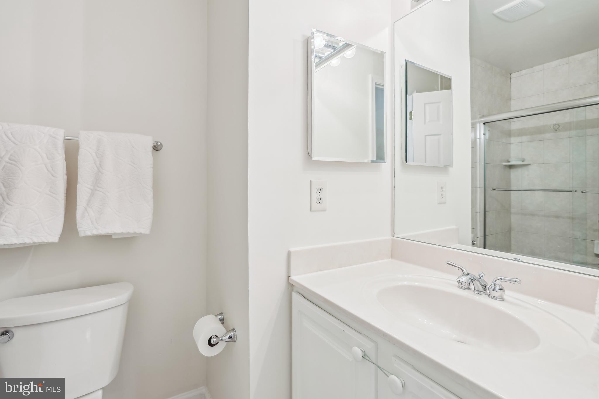 7122 Rolling Forest Avenue Springfield, VA 22152 - Photo 40 of 58 a bathroom with a granite countertop sink and a mirror