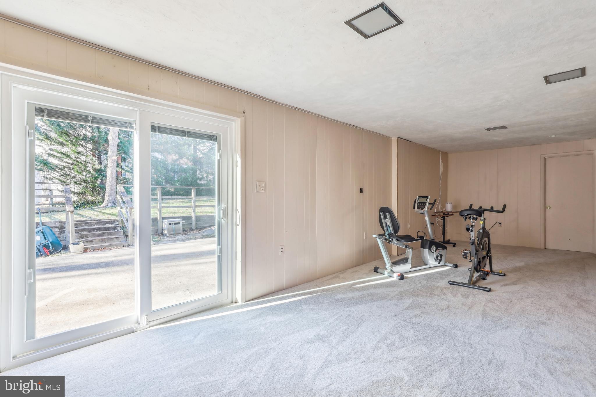 7122 Rolling Forest Avenue Springfield, VA 22152 - Photo 46 of 58 a view of a room with gym equipment and floor to ceiling window