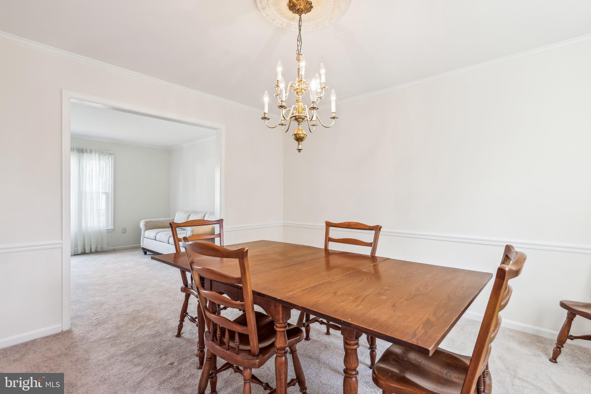 7122 Rolling Forest Avenue Springfield, VA 22152 - Photo 10 of 58 a view of a dining room with furniture and chandelier