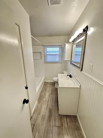 a storage room with wooden floor washer and dryer
