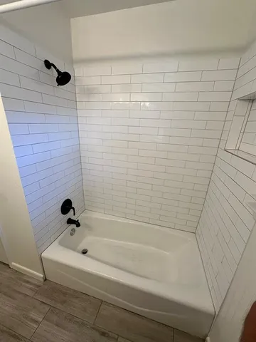 a bathroom with a shower and a bathtub