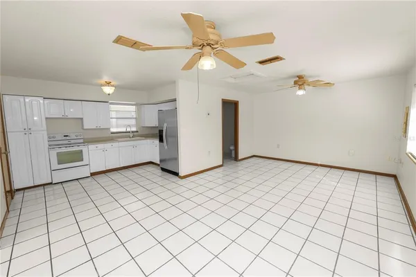 a living room with furniture and kitchen view