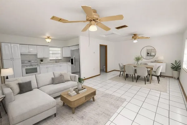 a view of a livingroom with an empty space and a ceiling fan