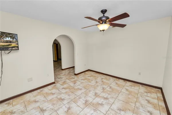 a view of a livingroom with a ceiling fan and window
