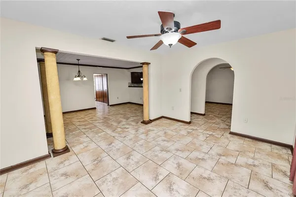 a view of a livingroom with a ceiling fan and entryway
