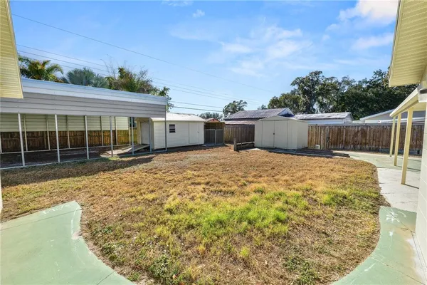 a front view of house with yard and trees in the background