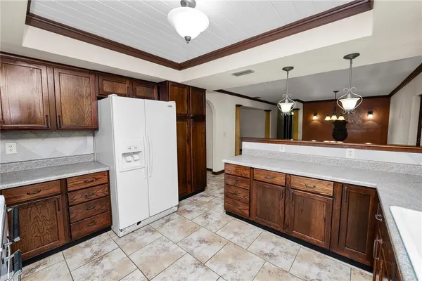 a kitchen with stainless steel appliances granite countertop a refrigerator and a sink
