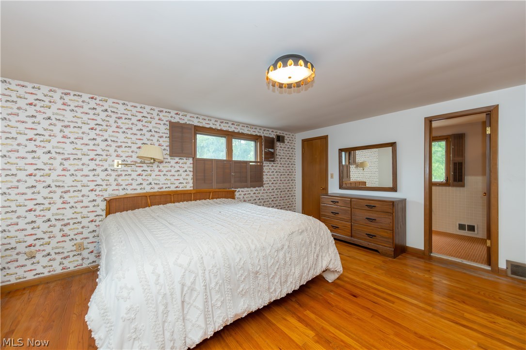 25001 Letchworth Road Beachwood, OH 44122 - Photo 36 of 50 Hardwood flooring throughout, with a decorative ceiling light fixture