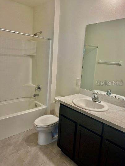 31284 Penny Surf Loop Wesley Chapel, FL 33545 - Photo 12 of 15 a bathroom with a granite countertop sink a toilet a mirror and a bathtub
