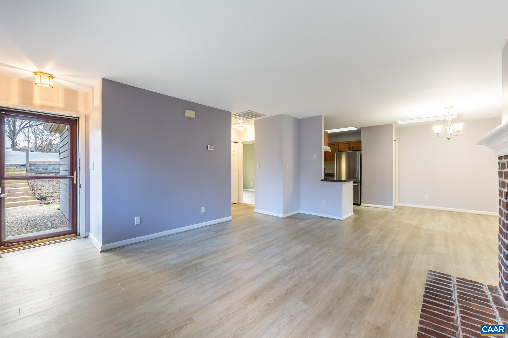 1006 Amber Ridge Road Charlottesville, VA 22901 - Photo 3 of 28 a view of an empty room with a fireplace and a window