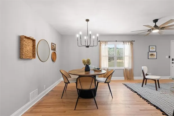 a view of a dining room with furniture and wooden floor