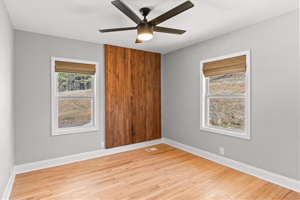 80 Hand Road Bowdon, GA 30108 - Photo 21 of 83 a view of an empty room with window and wooden floor