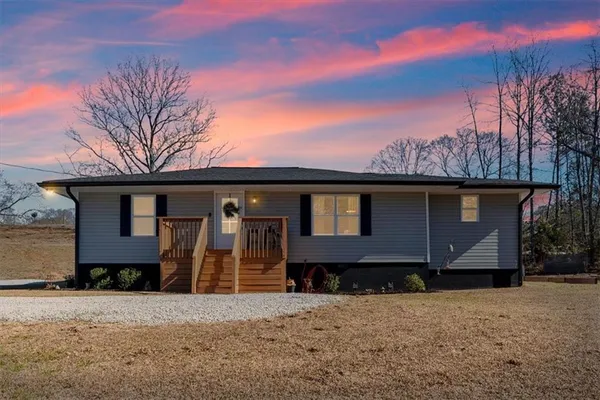 a view of a pathway with a wrought fence