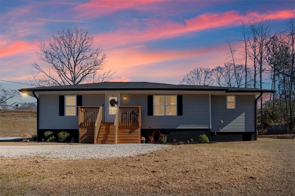 80 Hand Road Bowdon, GA 30108 - Photo 25 of 83 a front view of a house with a yard and garage