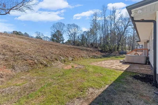 a view of dirt yard with large trees