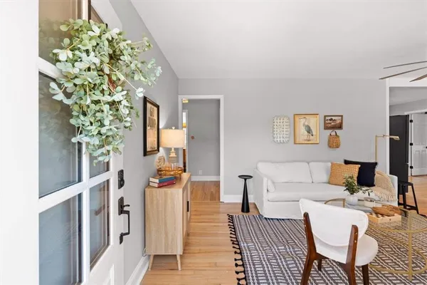 a living room with furniture a ceiling fan and a rug
