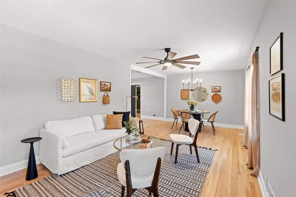 a living room with furniture and a chandelier