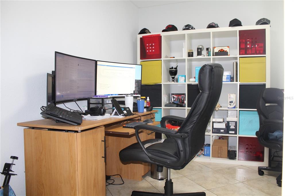 115 Willowbay Ridge Street Sanford, FL 32771 - Photo 13 of 28 a view of a workspace with furniture and a flat screen tv