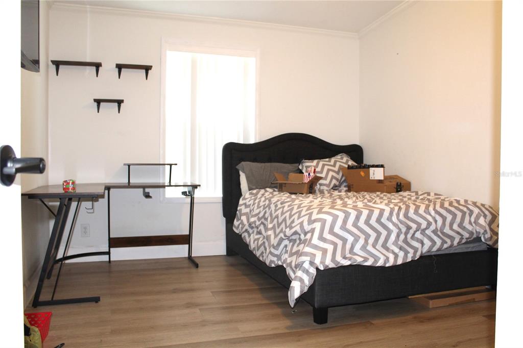 115 Willowbay Ridge Street Sanford, FL 32771 - Photo 20 of 28 a bedroom with a bed and a chandelier