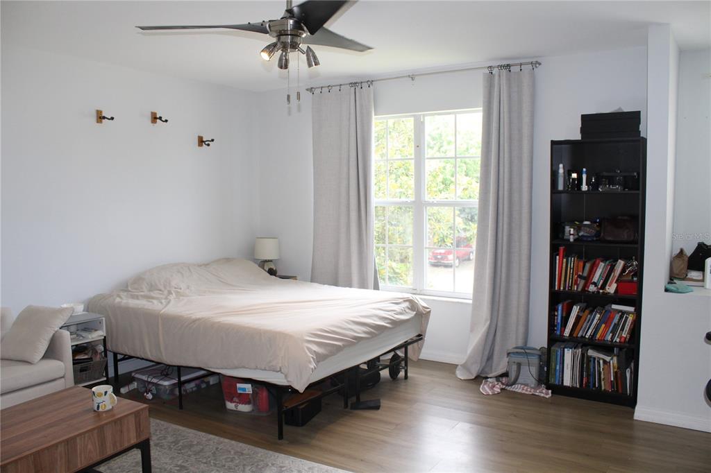 115 Willowbay Ridge Street Sanford, FL 32771 - Photo 21 of 28 a bedroom with a bed and a book shelf