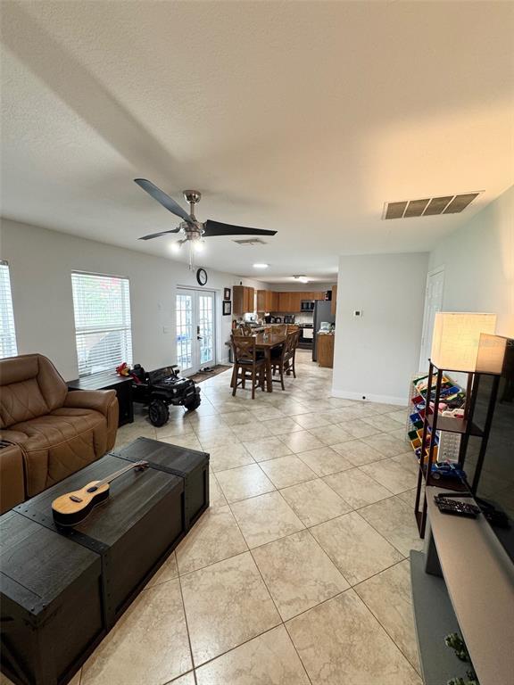 115 Willowbay Ridge Street Sanford, FL 32771 - Photo 10 of 28 a living room with furniture and a chandelier