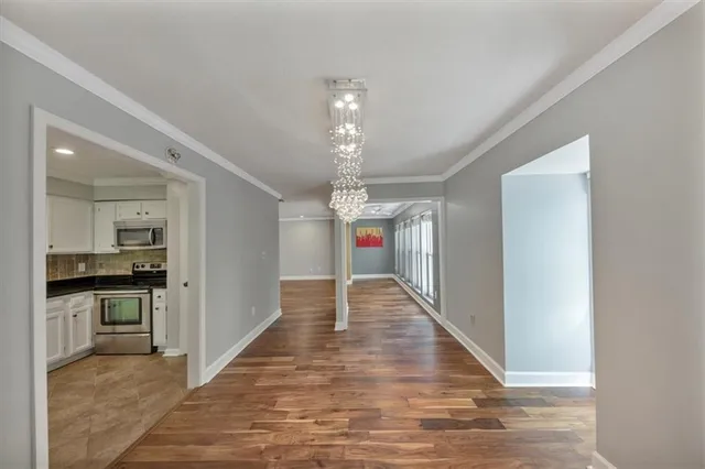 a kitchen with stainless steel appliances granite countertop a refrigerator sink and white cabinets