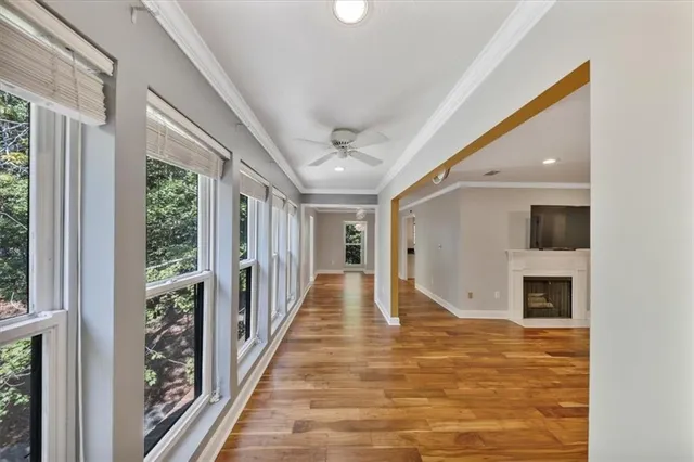 a view of a hallway with wooden floor and a chandelier