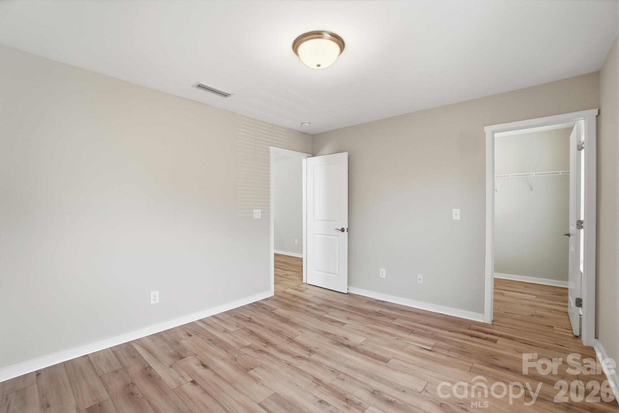 2153 Bluebell Way Tega Cay, SC 29708 - Photo 37 of 48 a view of an empty room with wooden floor and a window