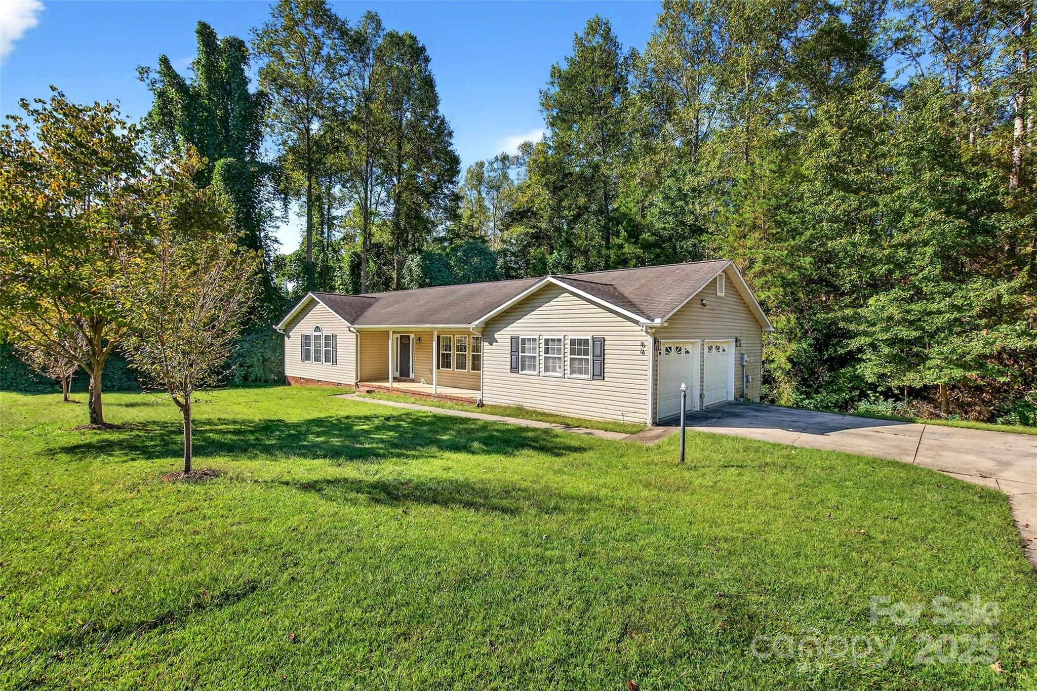 a front view of a house with a yard and trees
