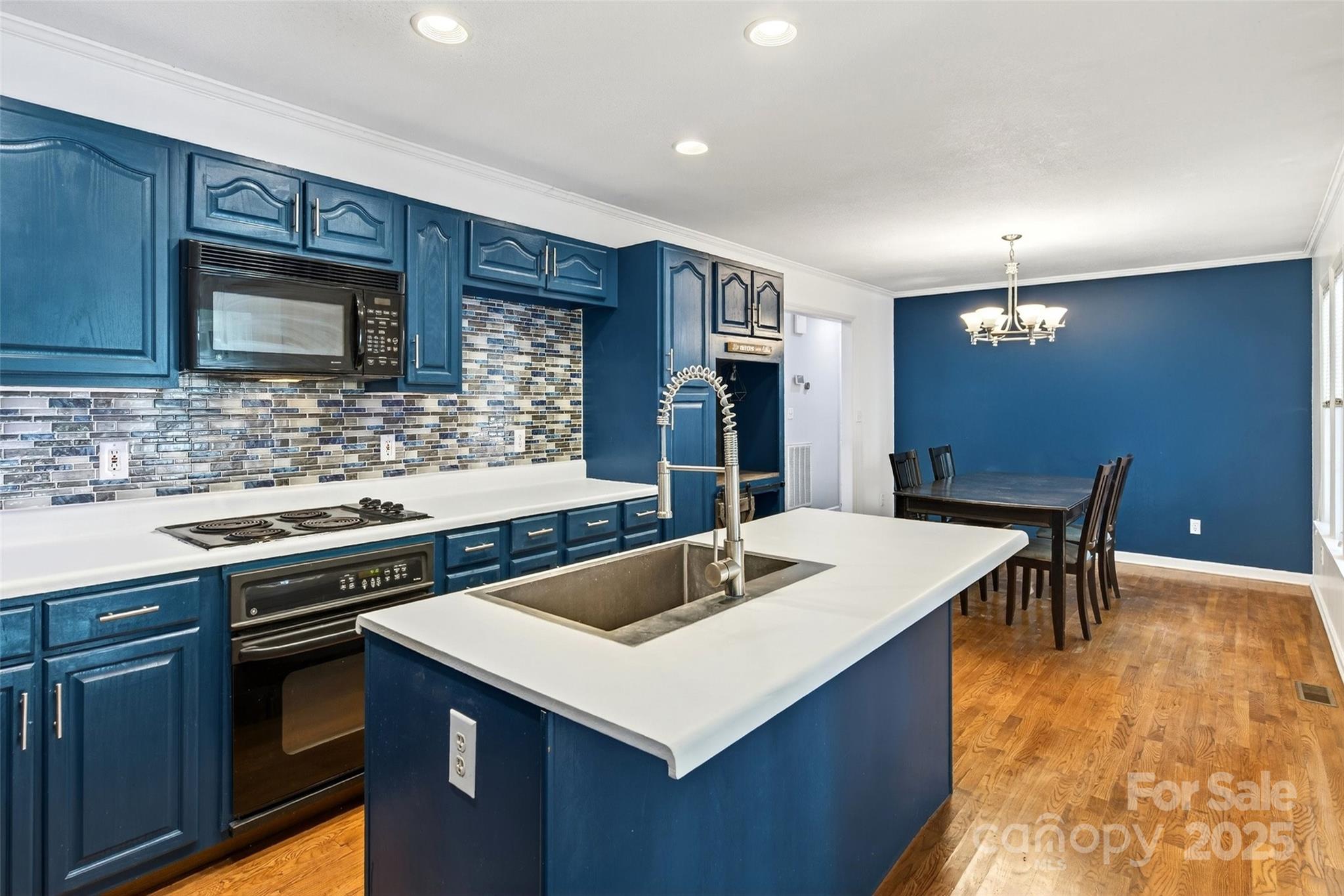86 Springdale Drive Marion, NC 28752 - Photo 11 of 40 a kitchen that has a sink a stove and chairs