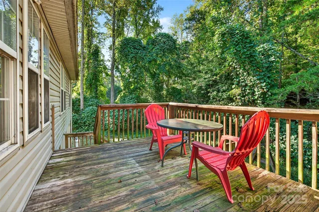a view of a deck with two chairs and wooden floor