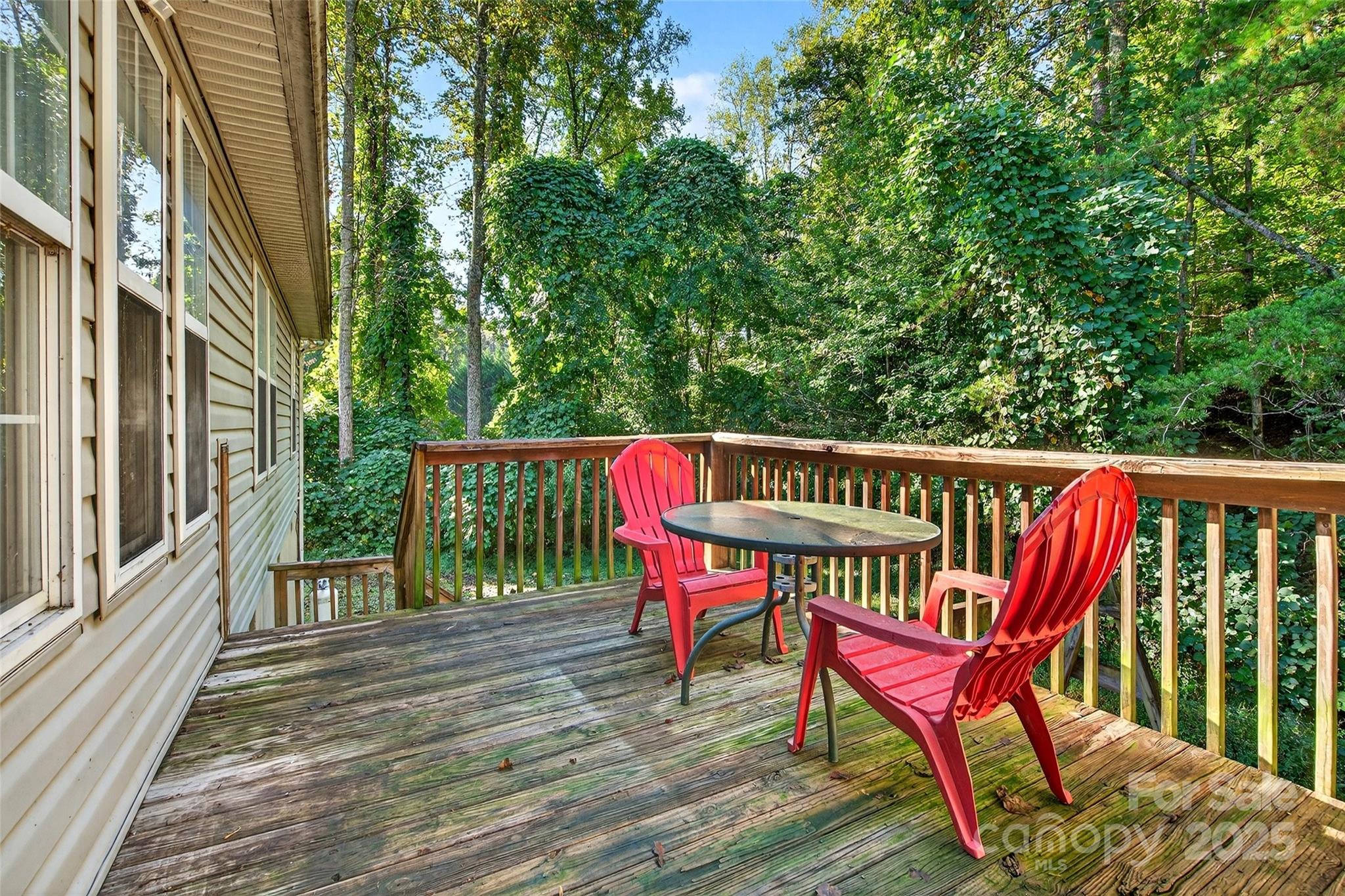 86 Springdale Drive Marion, NC 28752 - Photo 14 of 40 a view of a deck with two chairs and wooden floor