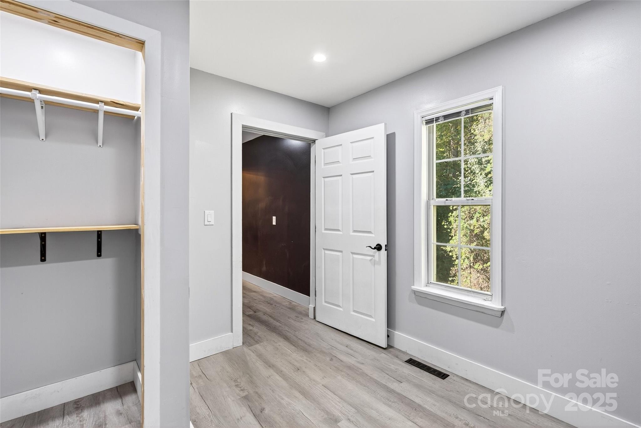 86 Springdale Drive Marion, NC 28752 - Photo 31 of 40 an empty room with wooden floor closet and windows