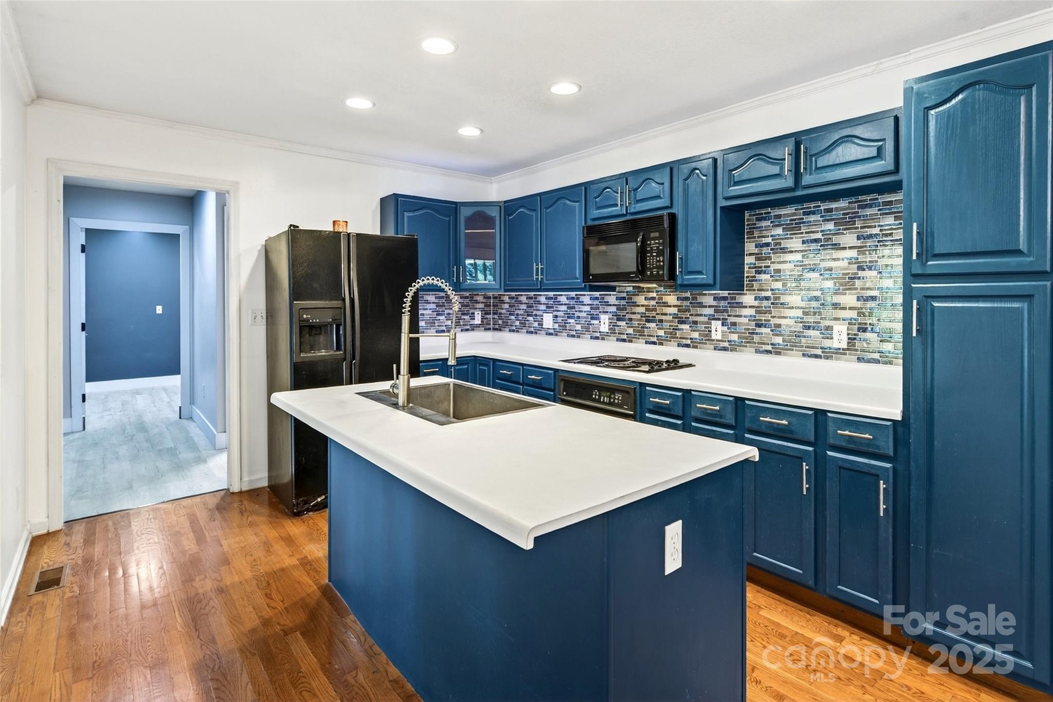 86 Springdale Drive Marion, NC 28752 - Photo 9 of 40 a kitchen with stainless steel appliances kitchen island a sink refrigerator and microwave