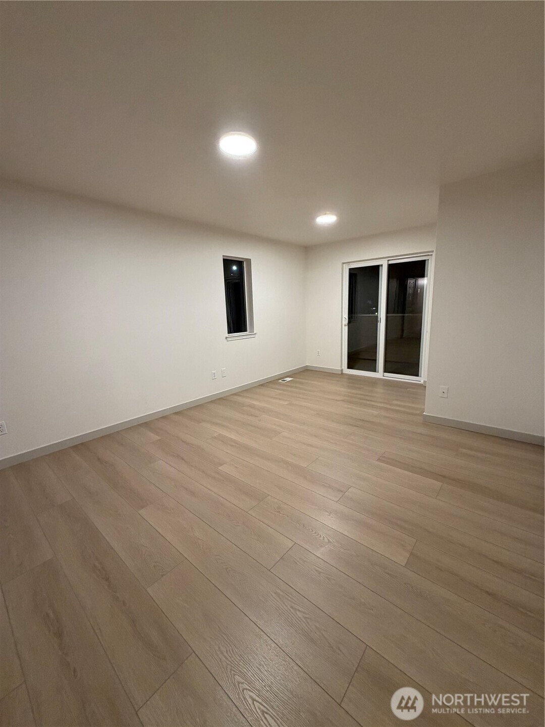 15409 51st Place West Edmonds, WA 98026 - Photo 13 of 14 a view of an empty room with wooden floor and a window