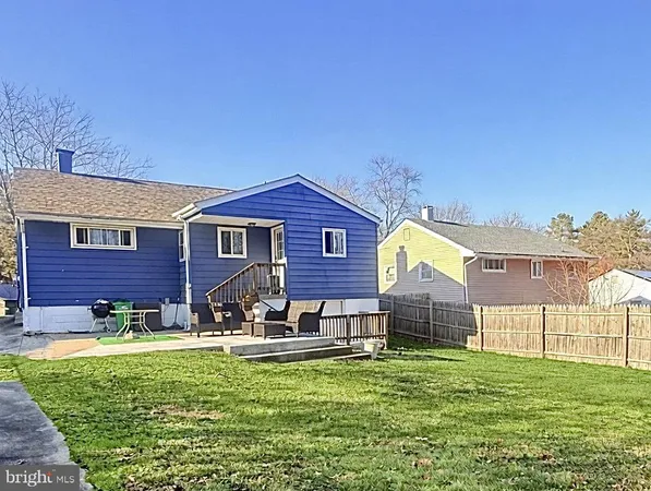 a front view of house with yard and outdoor seating