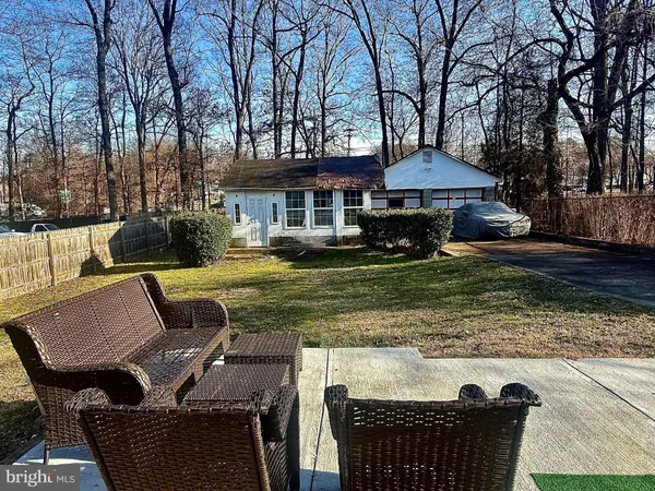 a view of a patio with couches chairs and a fire pit