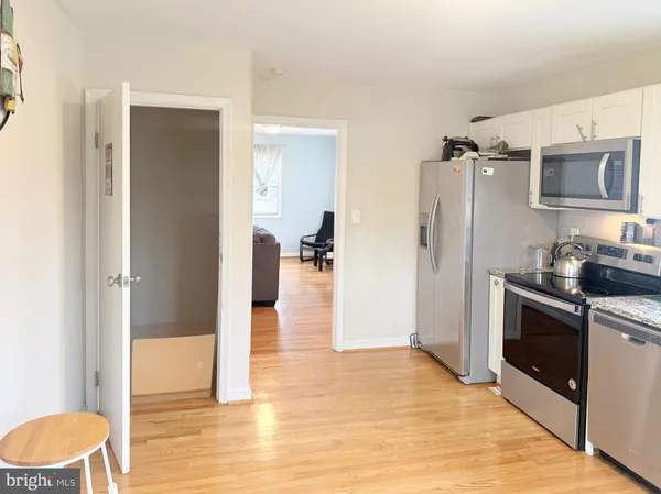 a kitchen with stainless steel appliances a refrigerator and a stove top oven