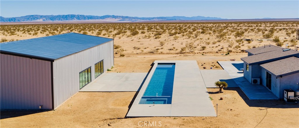 60810 Cole Lane Landers, CA 92285 - Photo 11 of 51 a view of swimming pool with a table and chairs