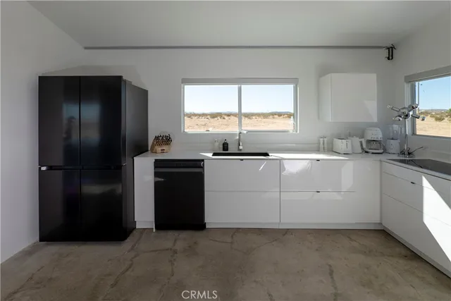 a kitchen with stainless steel appliances a sink stove and window