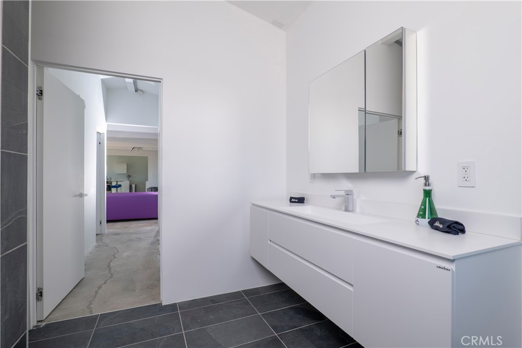 60810 Cole Lane Landers, CA 92285 - Photo 28 of 51 a bathroom with a double vanity sink and mirror