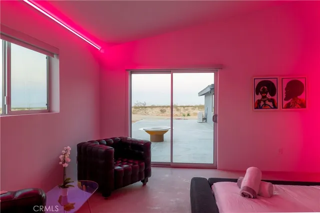 a bedroom with a bed and wall painting