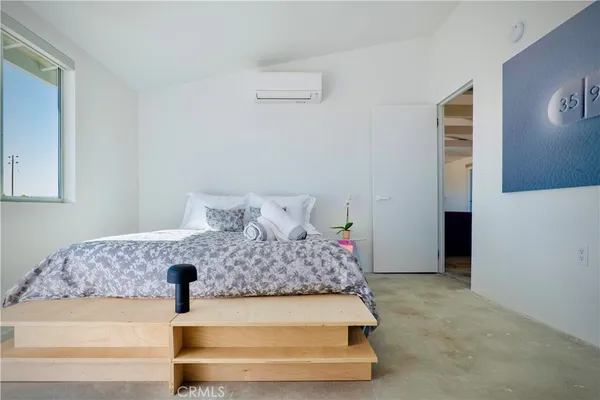 a bed room with a bed and a night stand