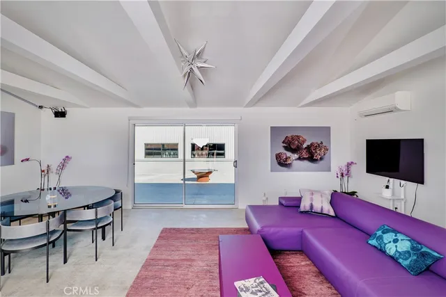 a living room with furniture or chandelier and a dining table