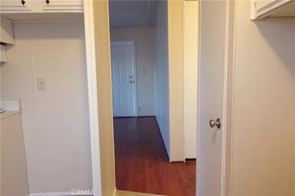 a view of a hallway with wooden floor