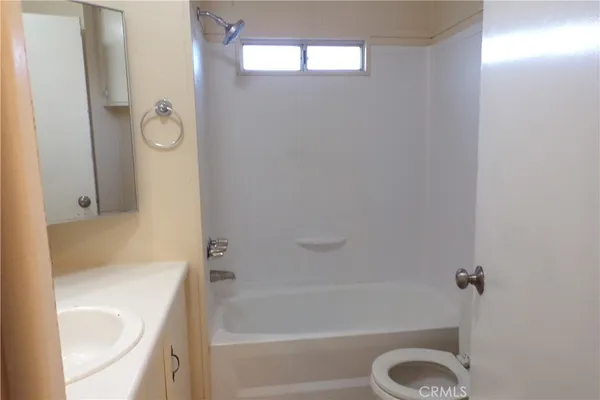 a bathroom with a tub a sink and a shower