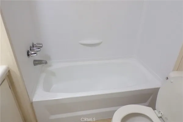 a bathroom with a bathtub and toilet