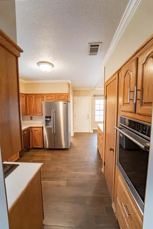 a view of a kitchen with a sink refrigerator and window