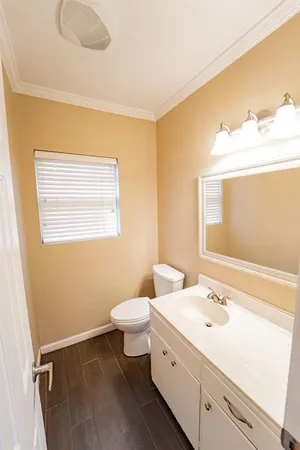 a bathroom with a sink vanity granite and toilet