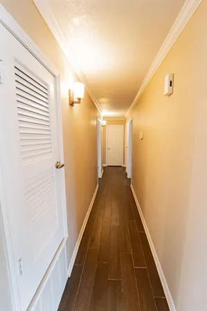 a view of a hallway with wooden floor